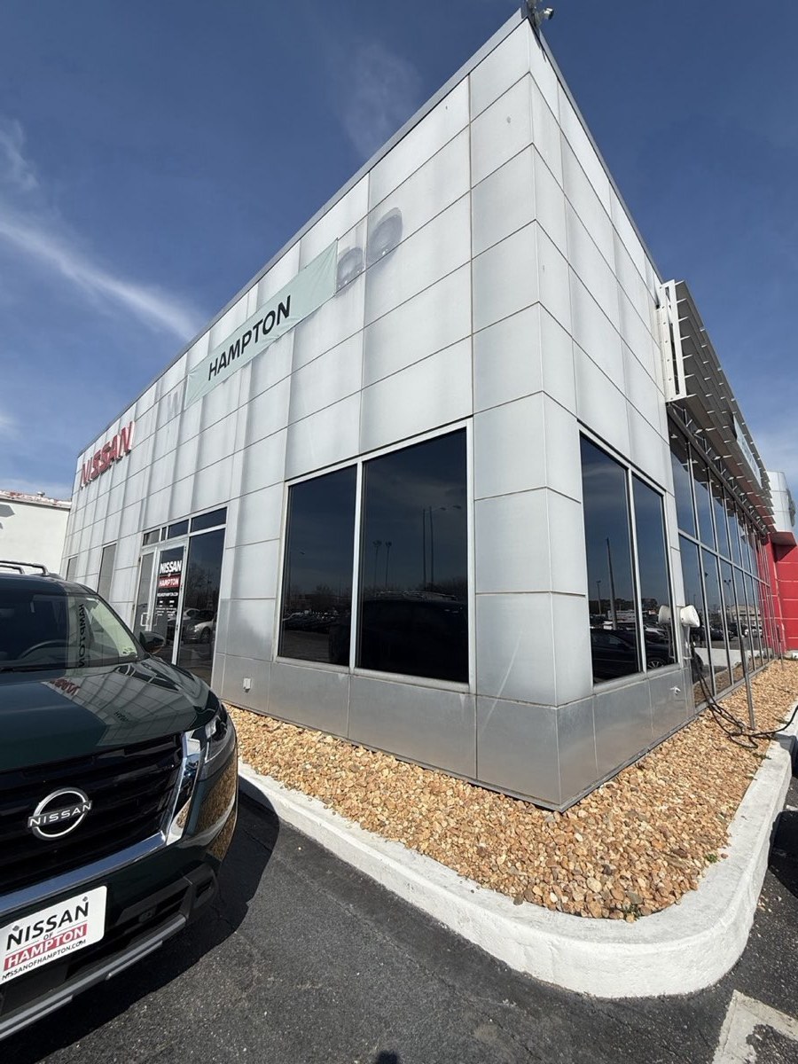 Car dealership exterior with reflective film on the showroom glass