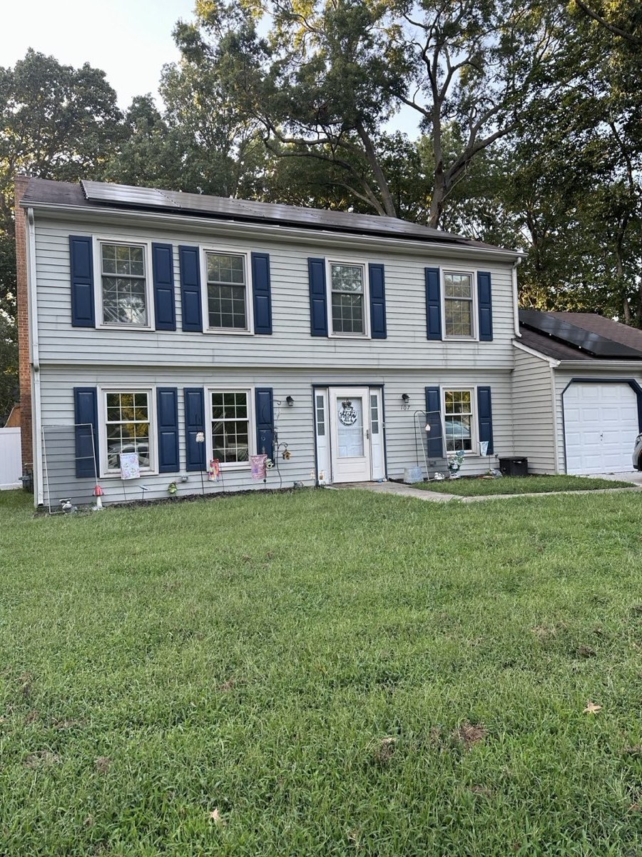 Two-story colonial house with window film on the front windows