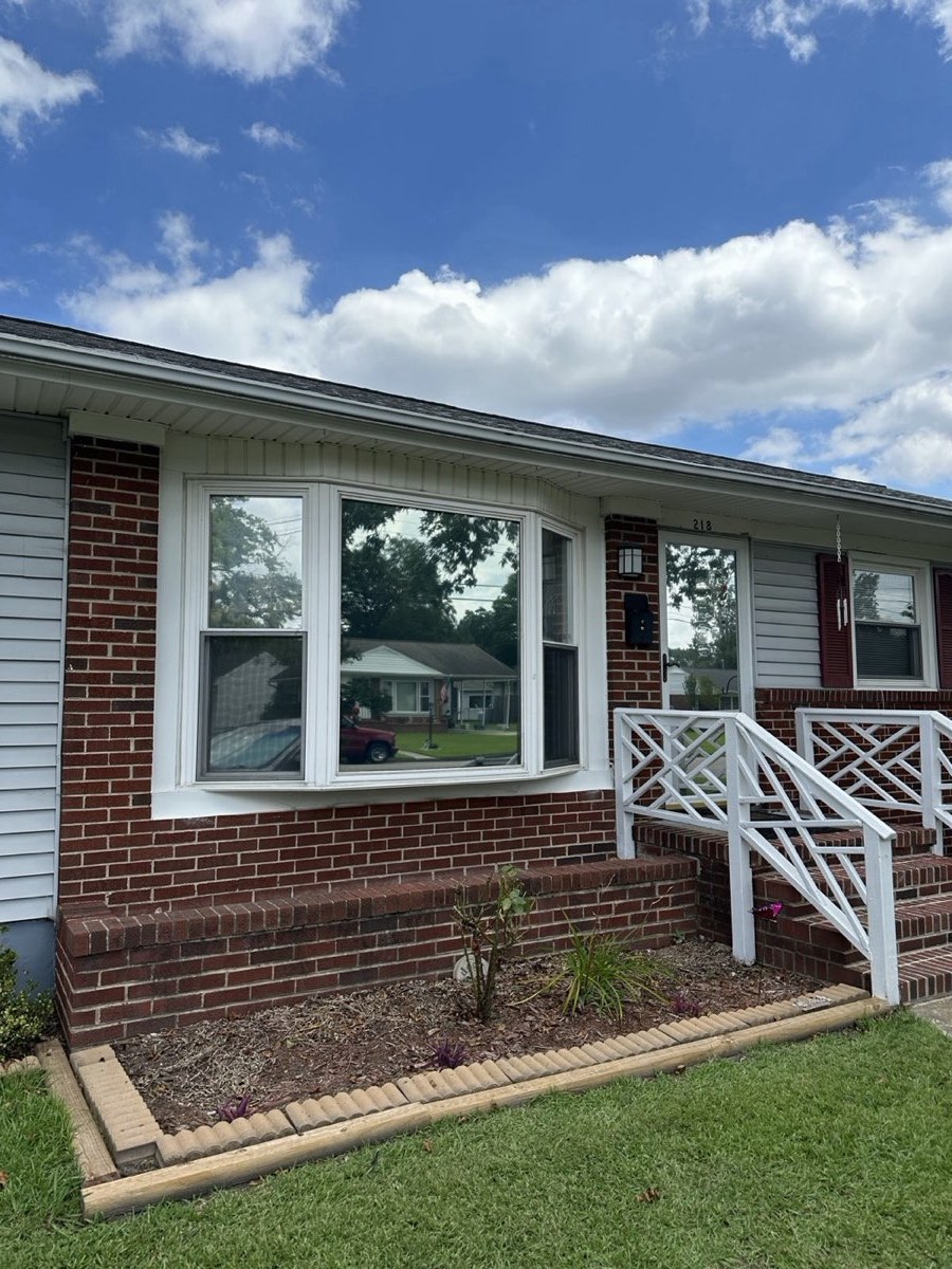 Brick ranch house with window film on the front windows