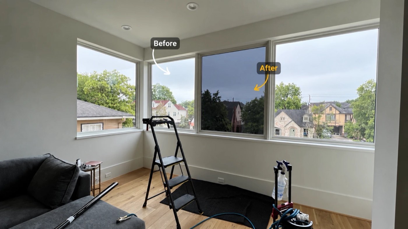 Living room with three windows: the middle one already filmed and noticeably darker than the untreated windows beside it